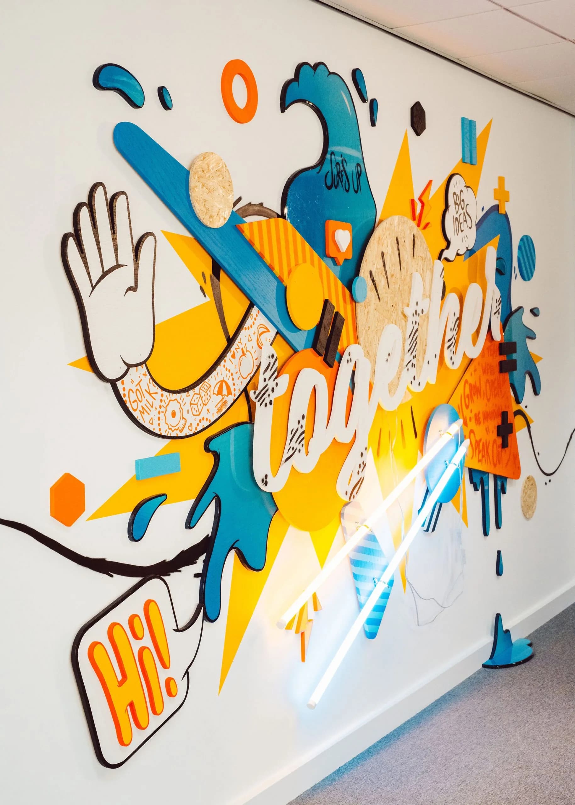 Colourful wall mural with the word "together", a waving hand and a "Hi!" speech bubble