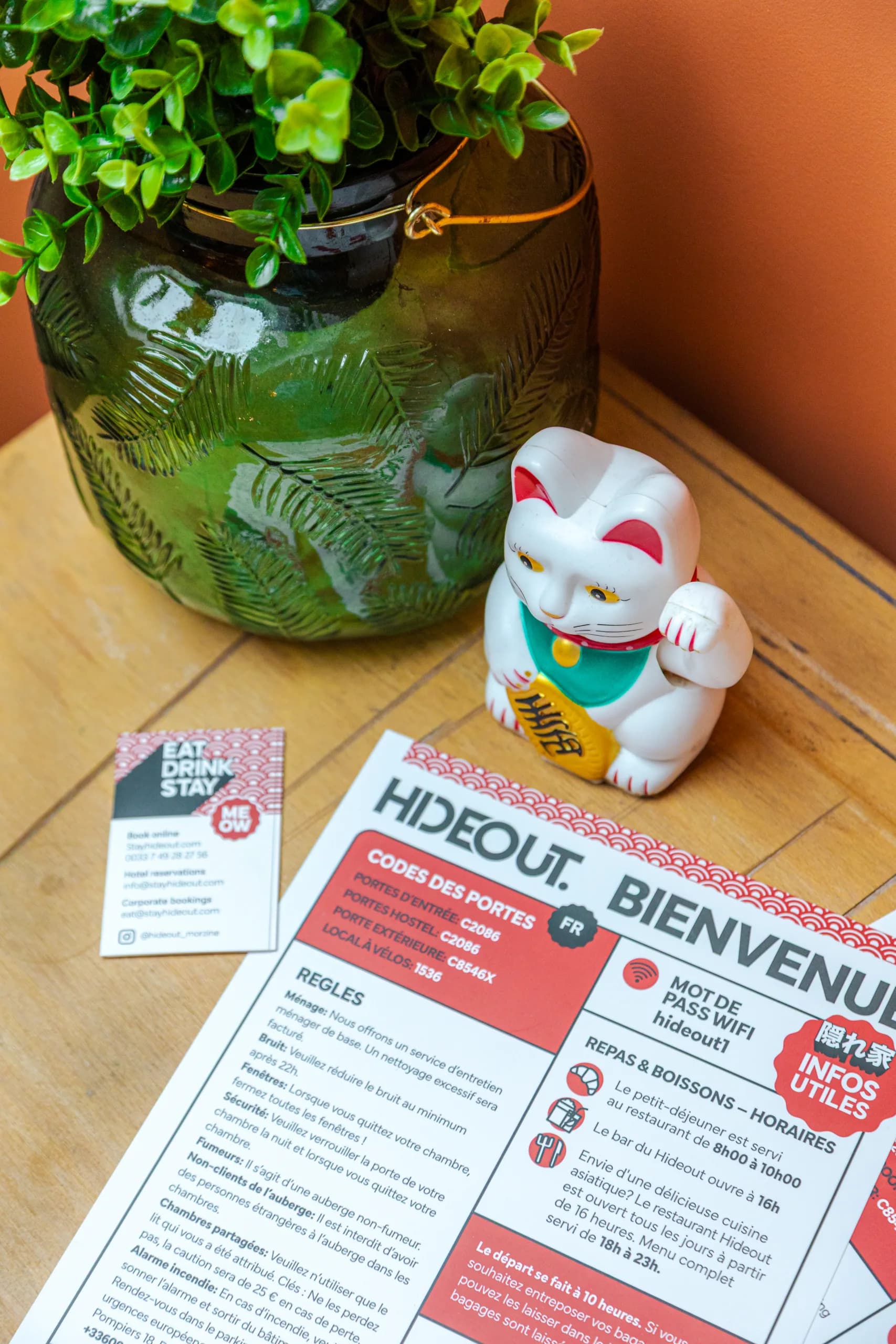 Willkommensinfos und Lucky-Katzenfigur in Zimmer 8 im Hideout